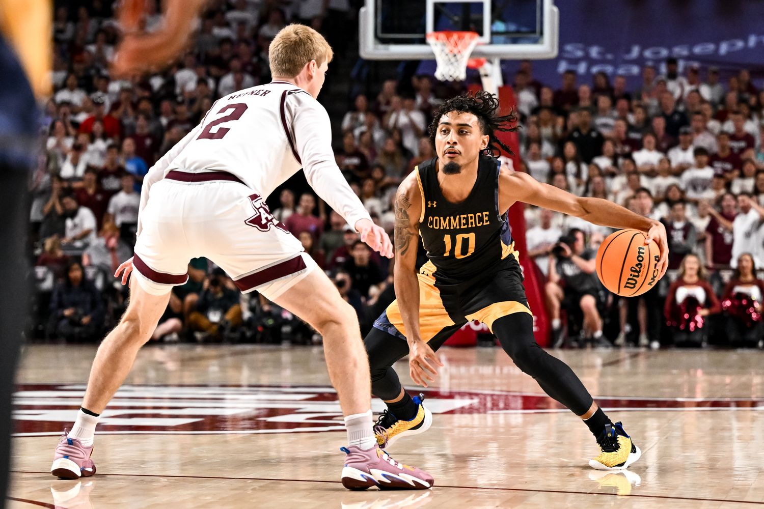 Nov 6, 2023; College Station, Texas, USA; Texas A&M Commerce guard Alonzo Dodd (10) controls the ball as Texas A&M Aggies guard Hayden Hefner (2) defends during the first half at Reed Arena. 